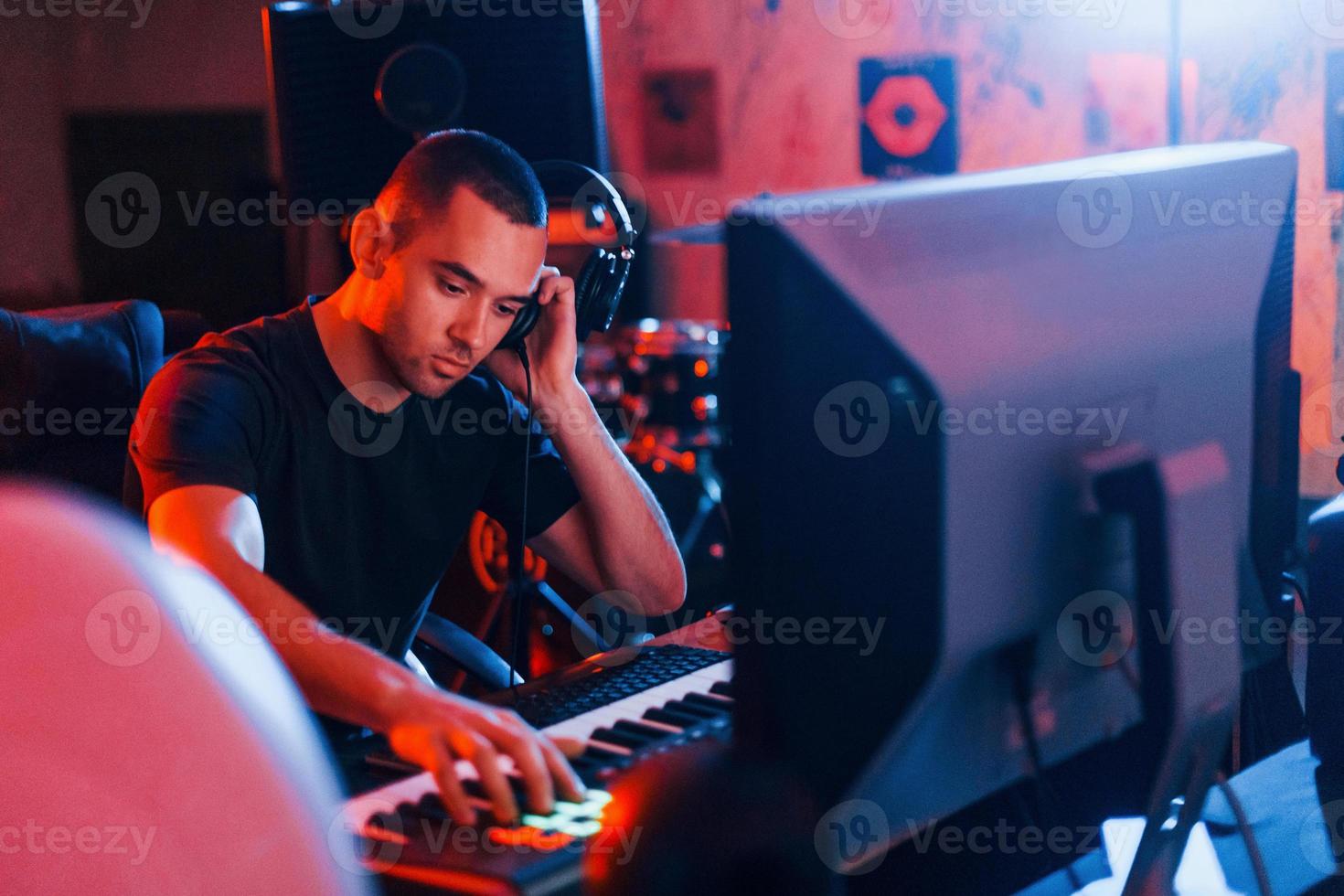 Sound engineer working and mixing music indoors in the studio photo