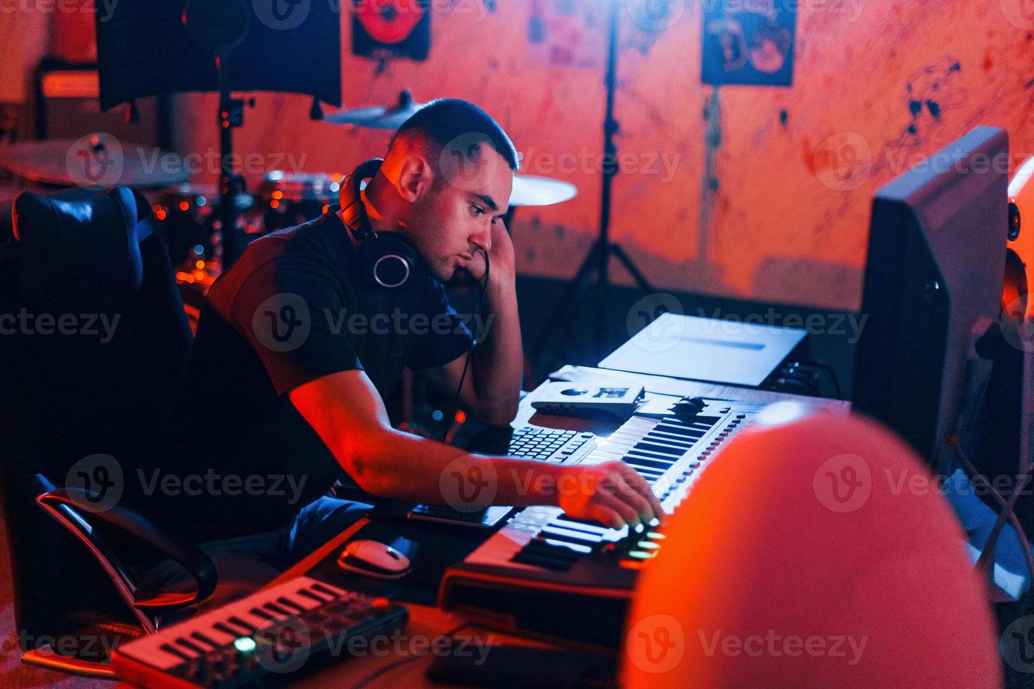 Sound engineer working and mixing music indoors in the studio photo