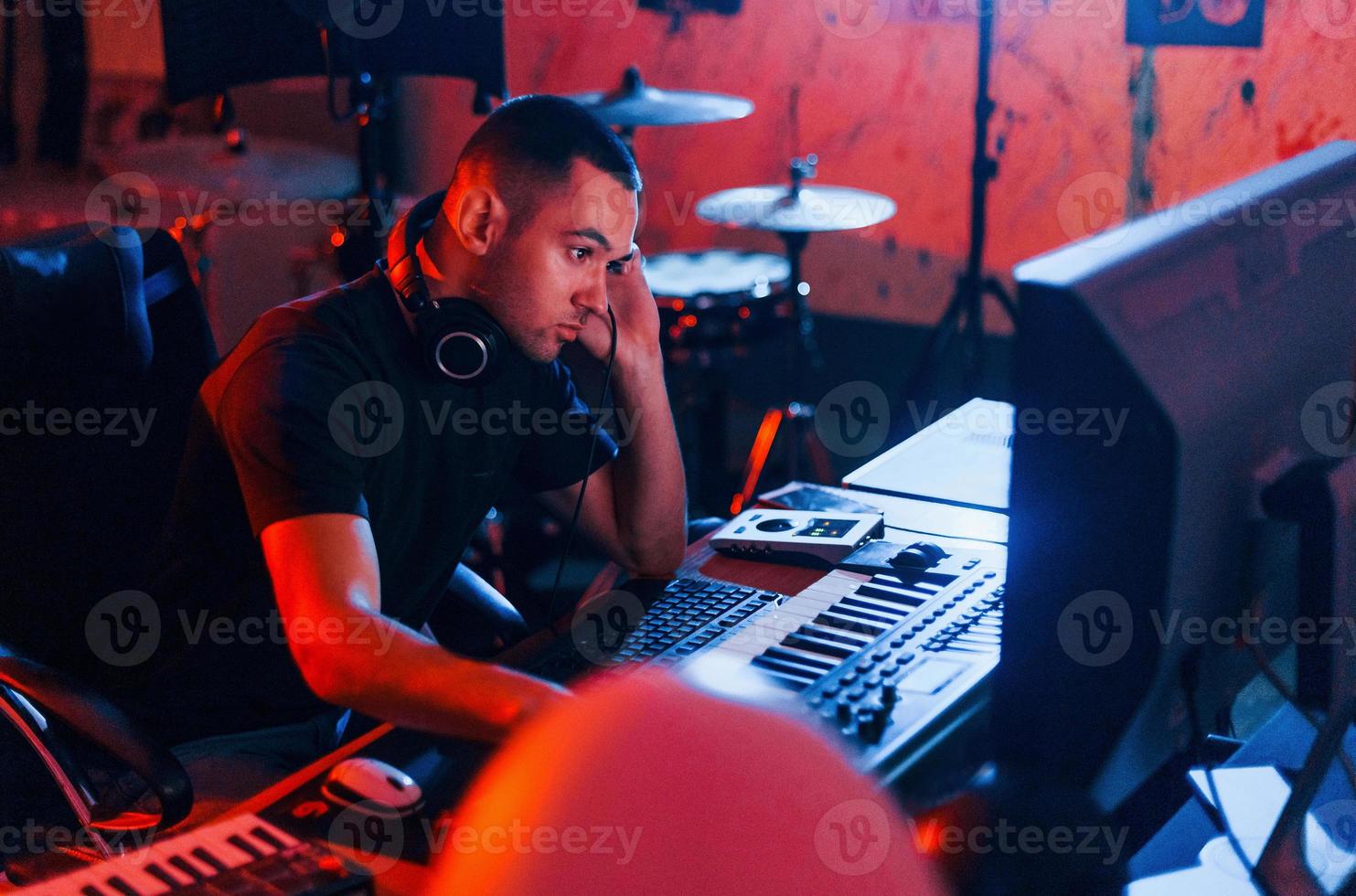 Sound engineer working and mixing music indoors in the studio photo