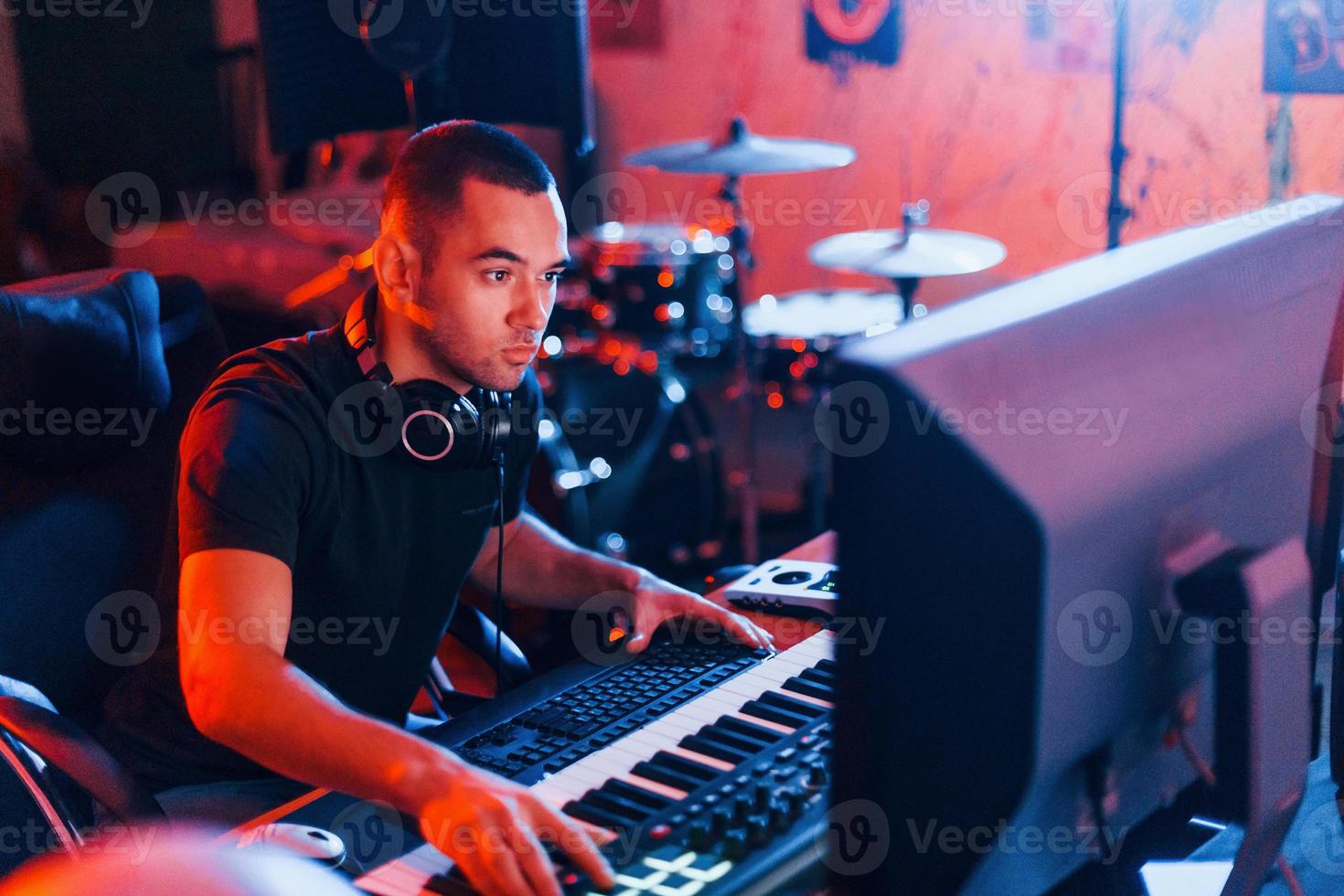 Sound engineer working and mixing music indoors in the studio photo