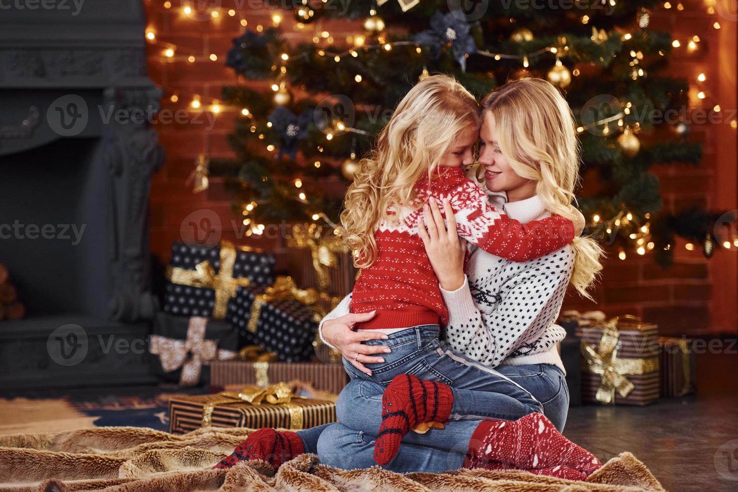 Mother and little girl having fun and celebrating christmas holidays photo