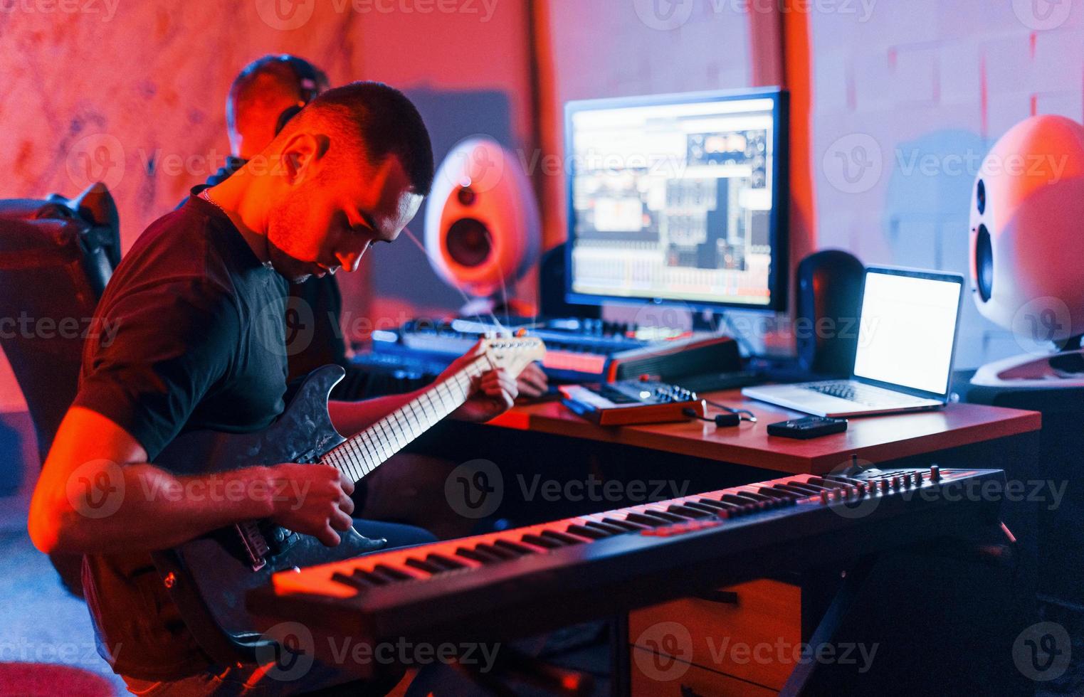 Guy have a job with project and mixing music indoors in the studio photo