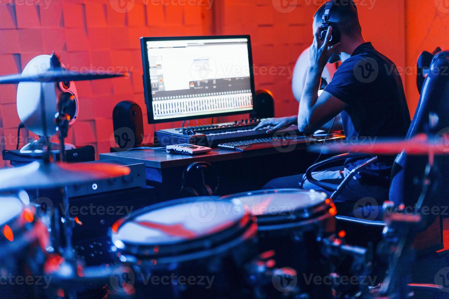 Guy have a job with project and mixing music indoors in the studio photo