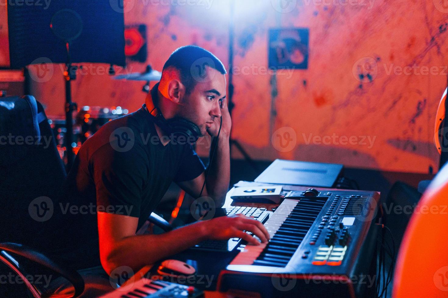 Sound engineer working and mixing music indoors in the studio photo