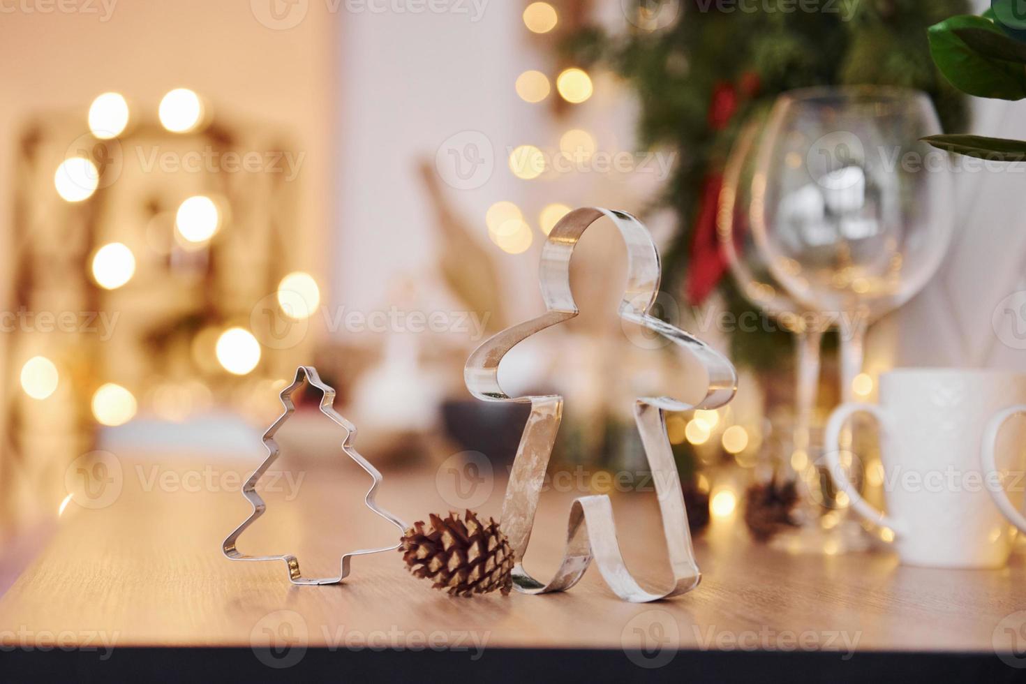 Glasses and x-mas decorations in the room. Bright garlands and lights photo