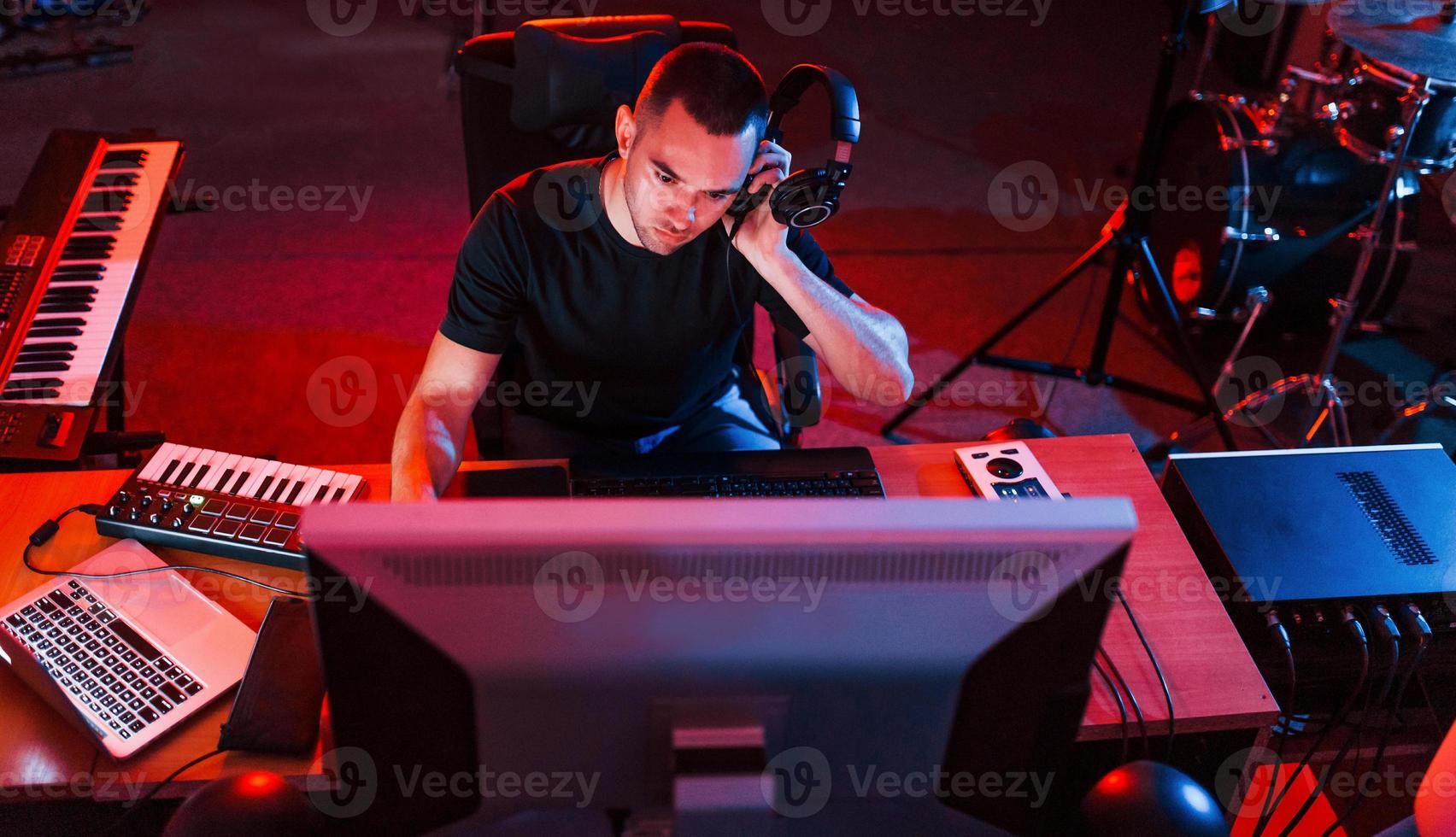 Professional sound engineer working and mixing music indoors in the