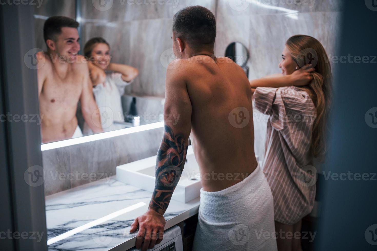 Young couple together in the bathroom at morning time photo