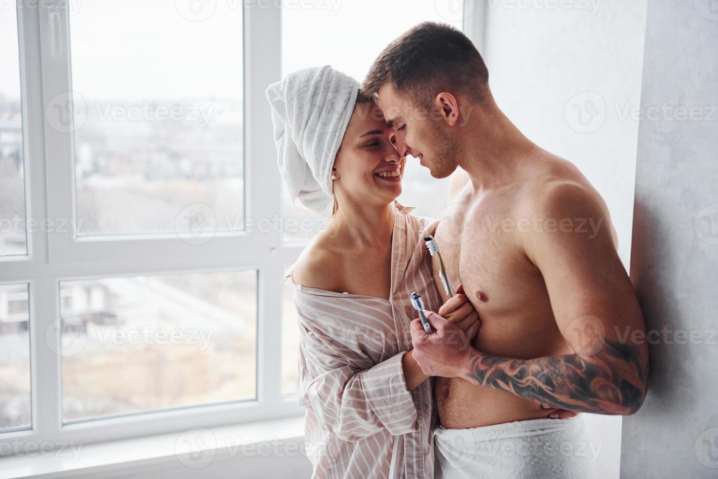 Couple at morning rime after the shower standing together photo