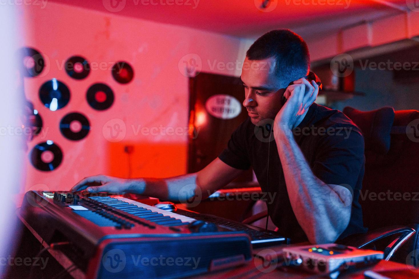 Professional sound engineer working and mixing music indoors in the studio photo