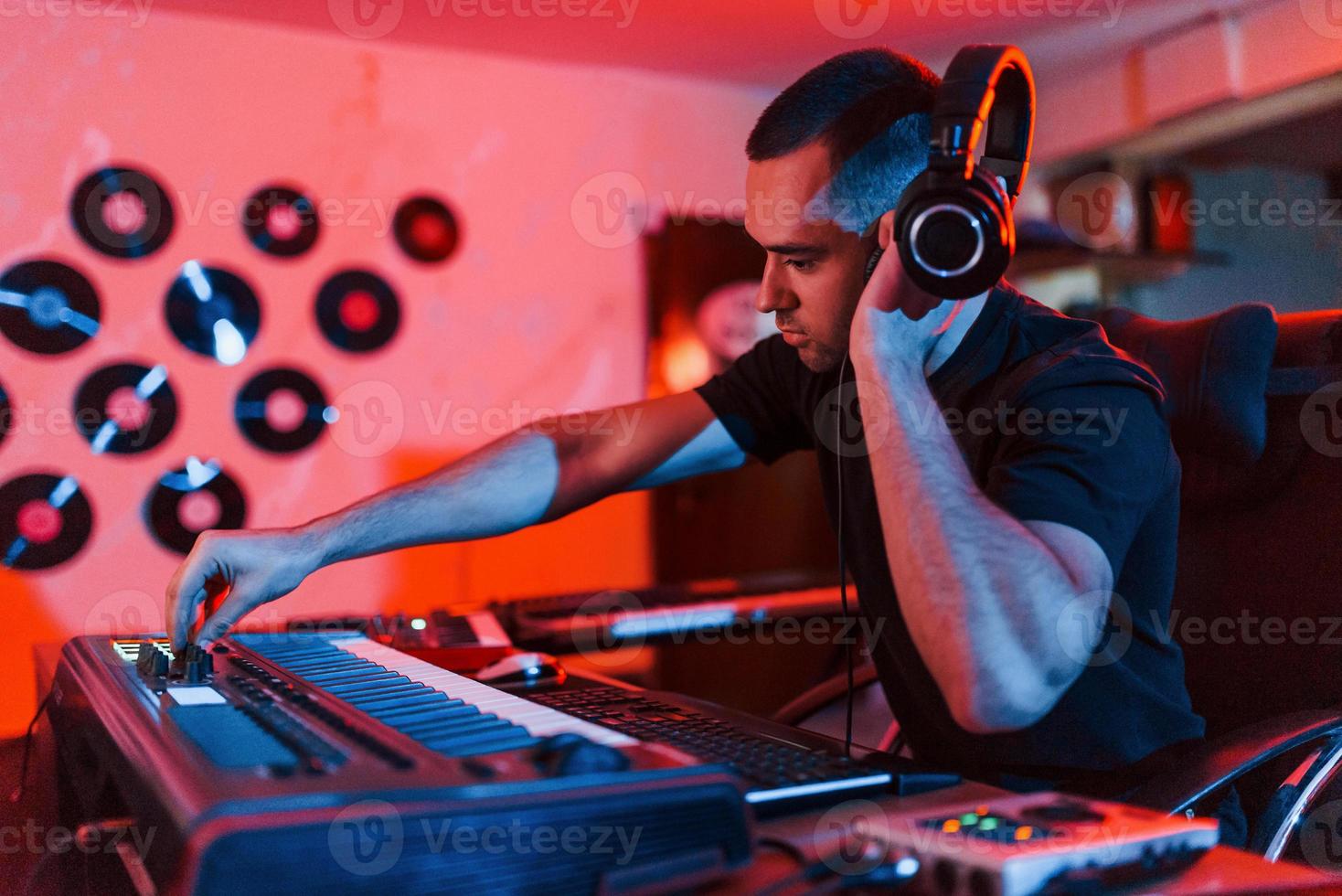 Professional sound engineer working and mixing music indoors in the studio photo