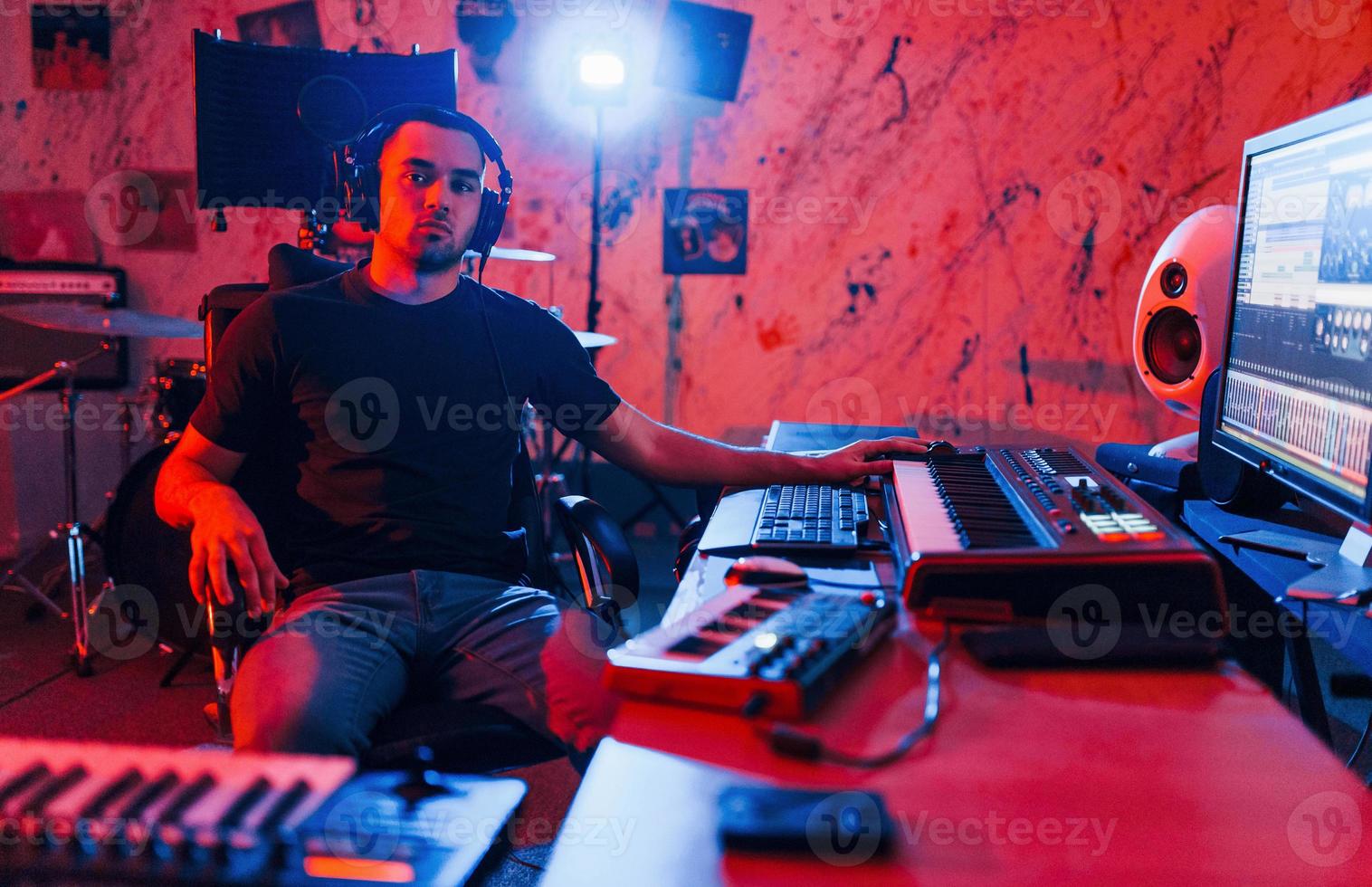 Professional sound engineer working and mixing music indoors in the studio photo