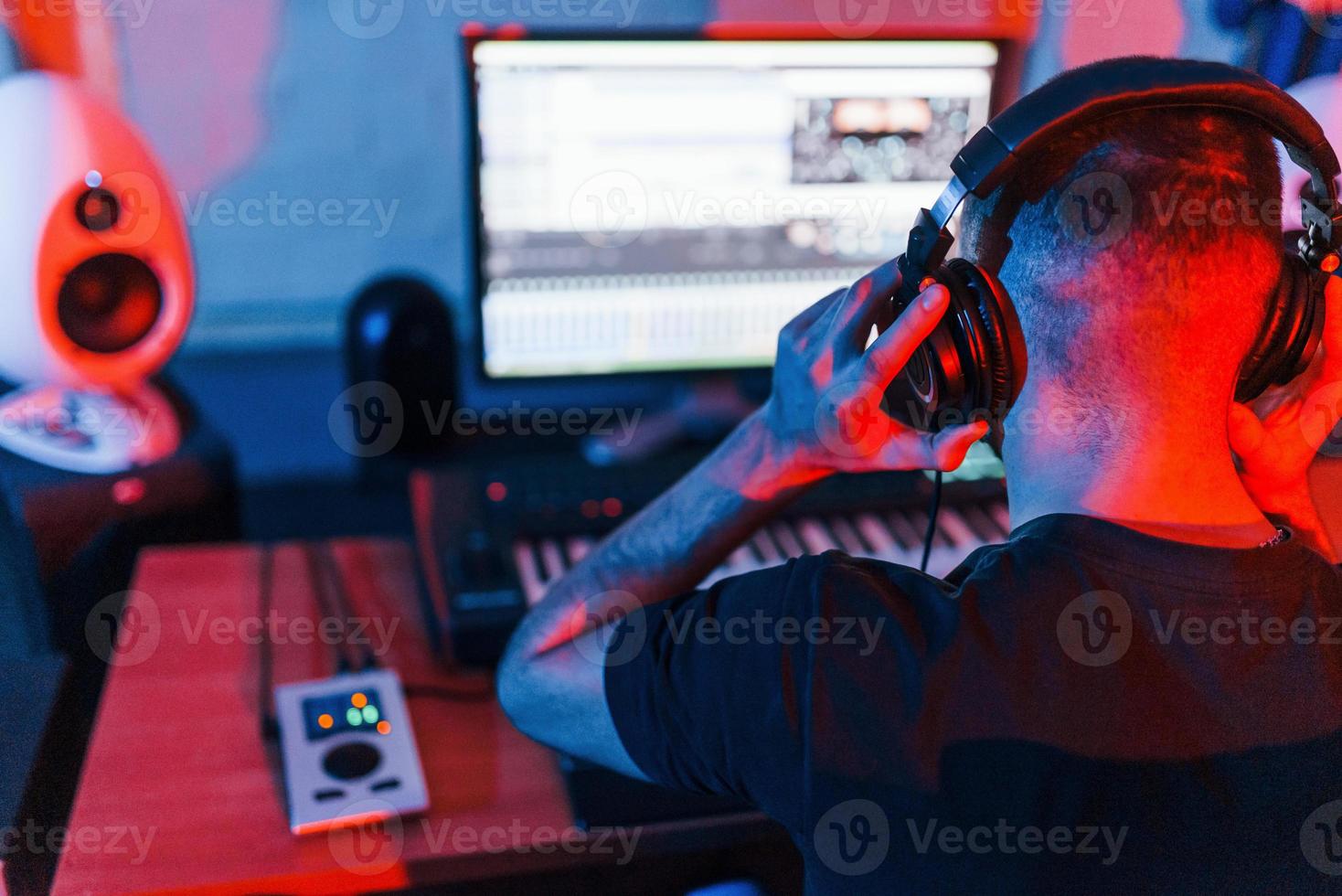 Professional sound engineer working and mixing music indoors in the studio photo
