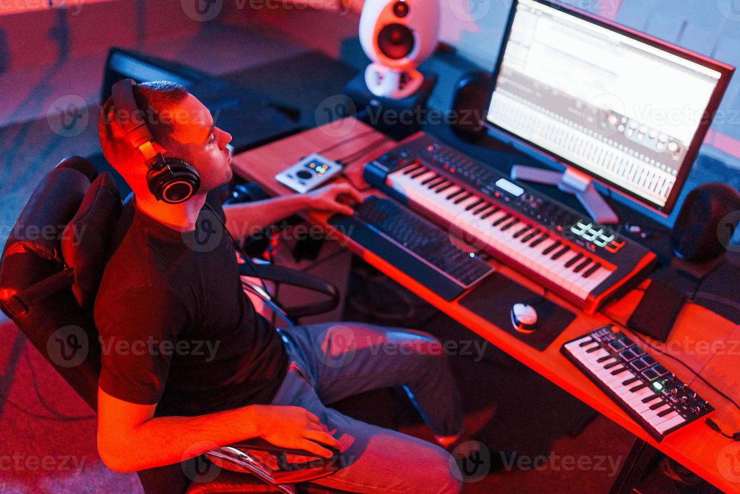 Professional sound engineer working and mixing music indoors in the studio photo