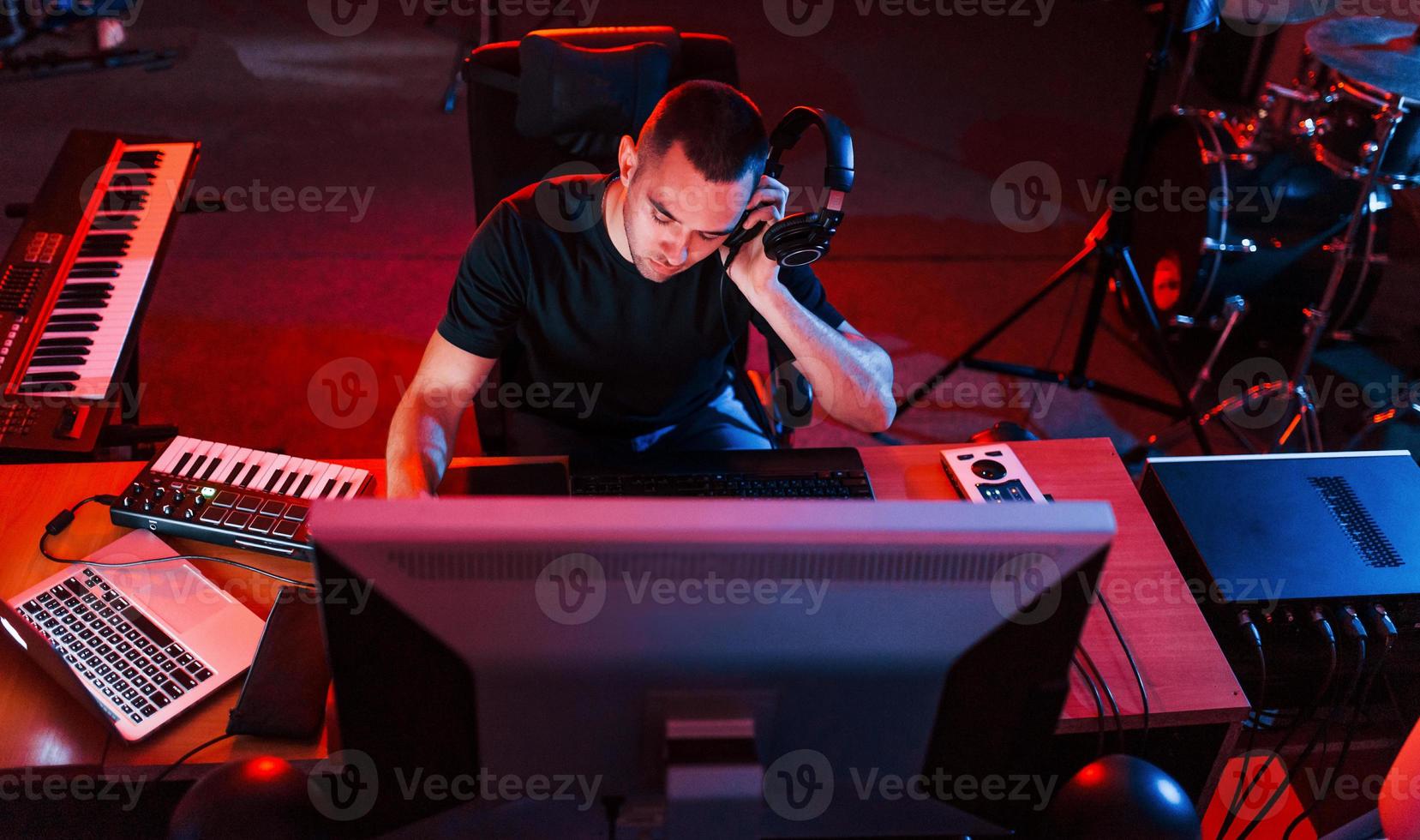 Professional sound engineer working and mixing music indoors in the studio photo