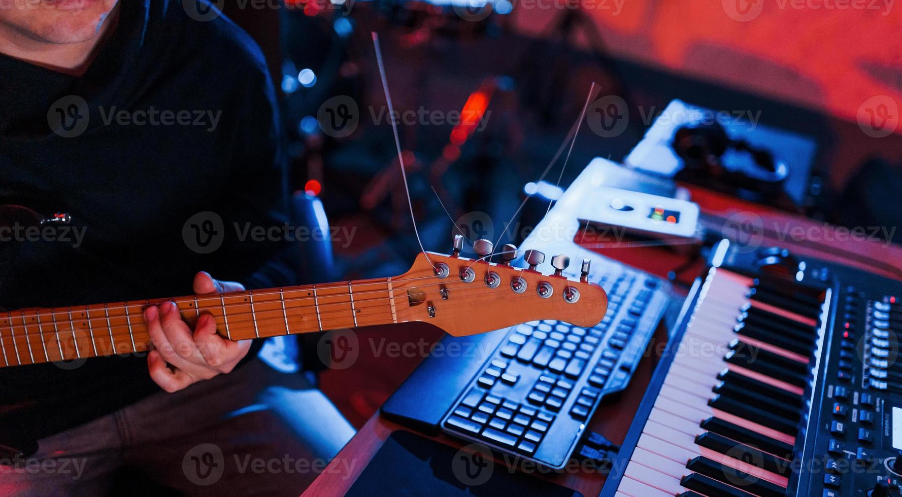 Guitar player have recording session indoors in the studio photo
