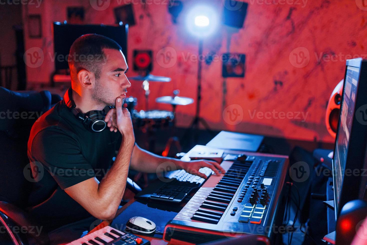 Professional sound engineer working and mixing music indoors in the studio photo