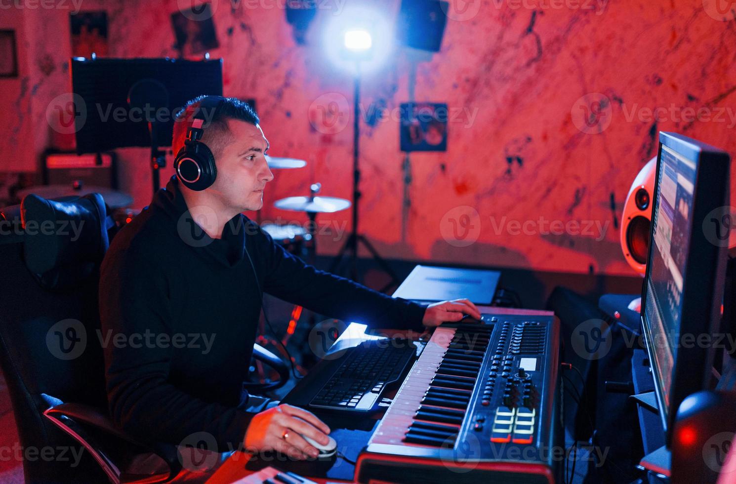 Young soung engineer working and mixing music indoors in the studio photo