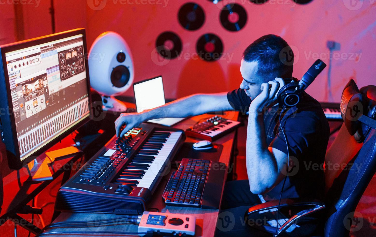 Young soung engineer working and mixing music indoors in the studio photo