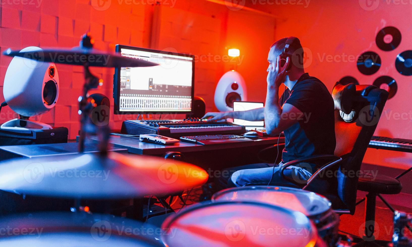 Young soung engineer working and mixing music indoors in the studio photo