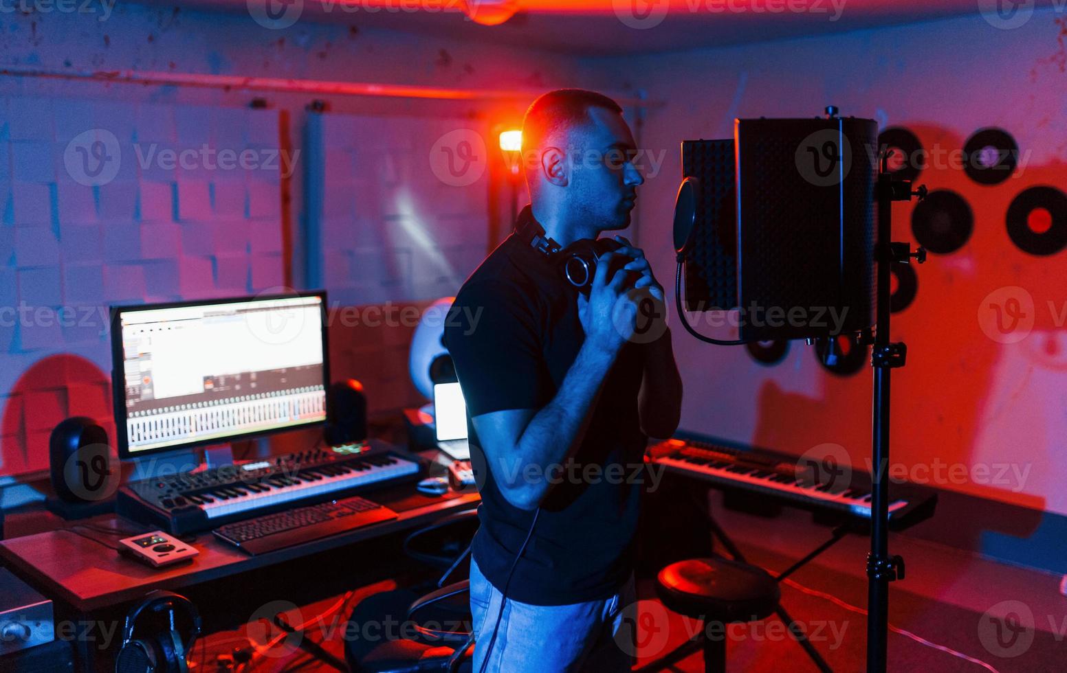 Vocalist have recording session indoors in the modern professional studio photo