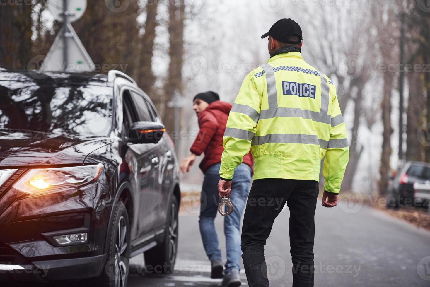 Police officer in green uniform caught automobile theft on the road photo