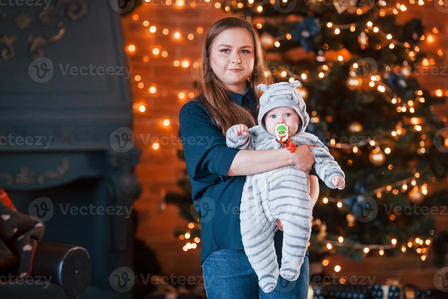 Mother with her child together in christmas decorated room photo