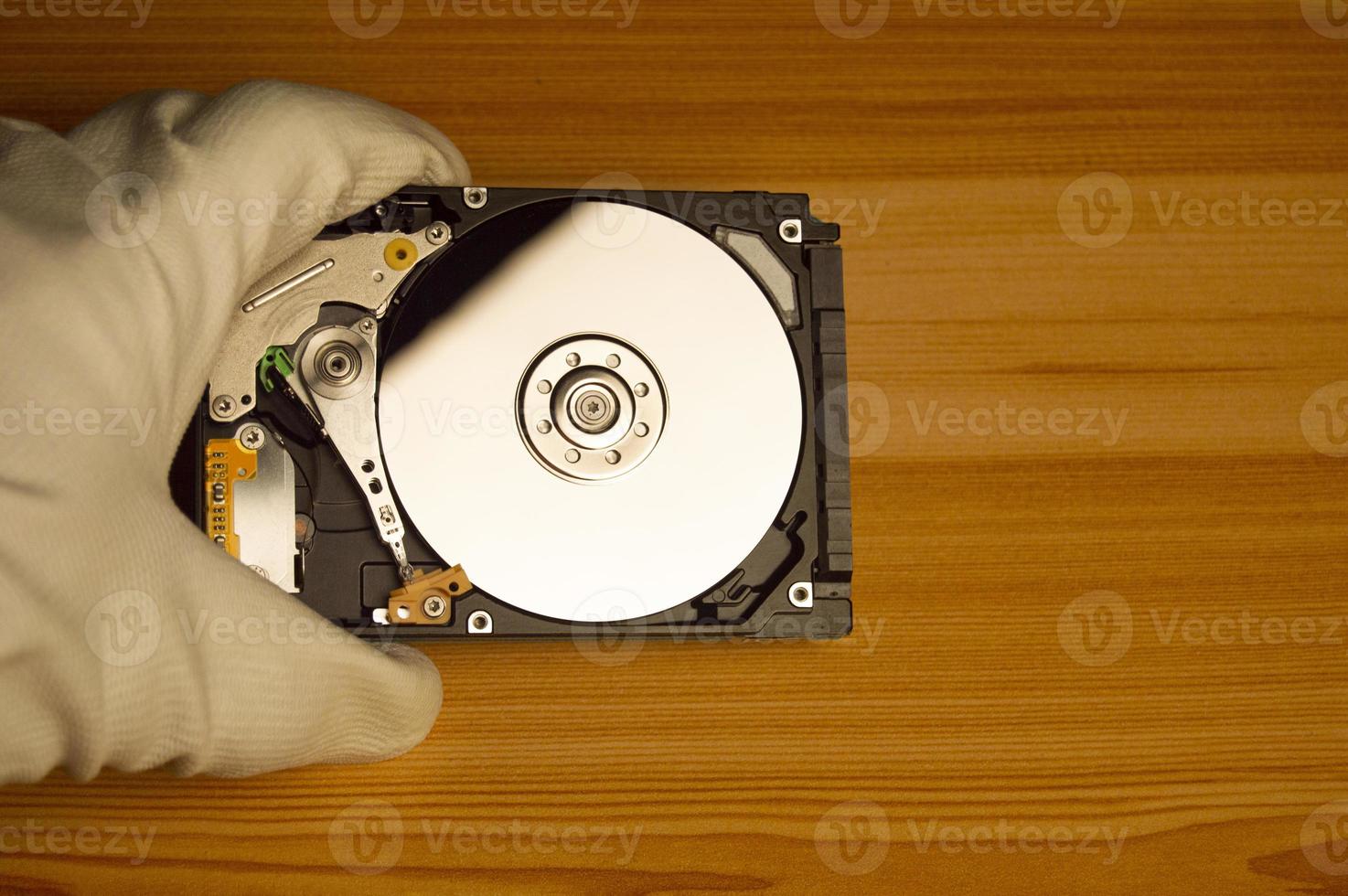 top view mechanic holding hard drive photo