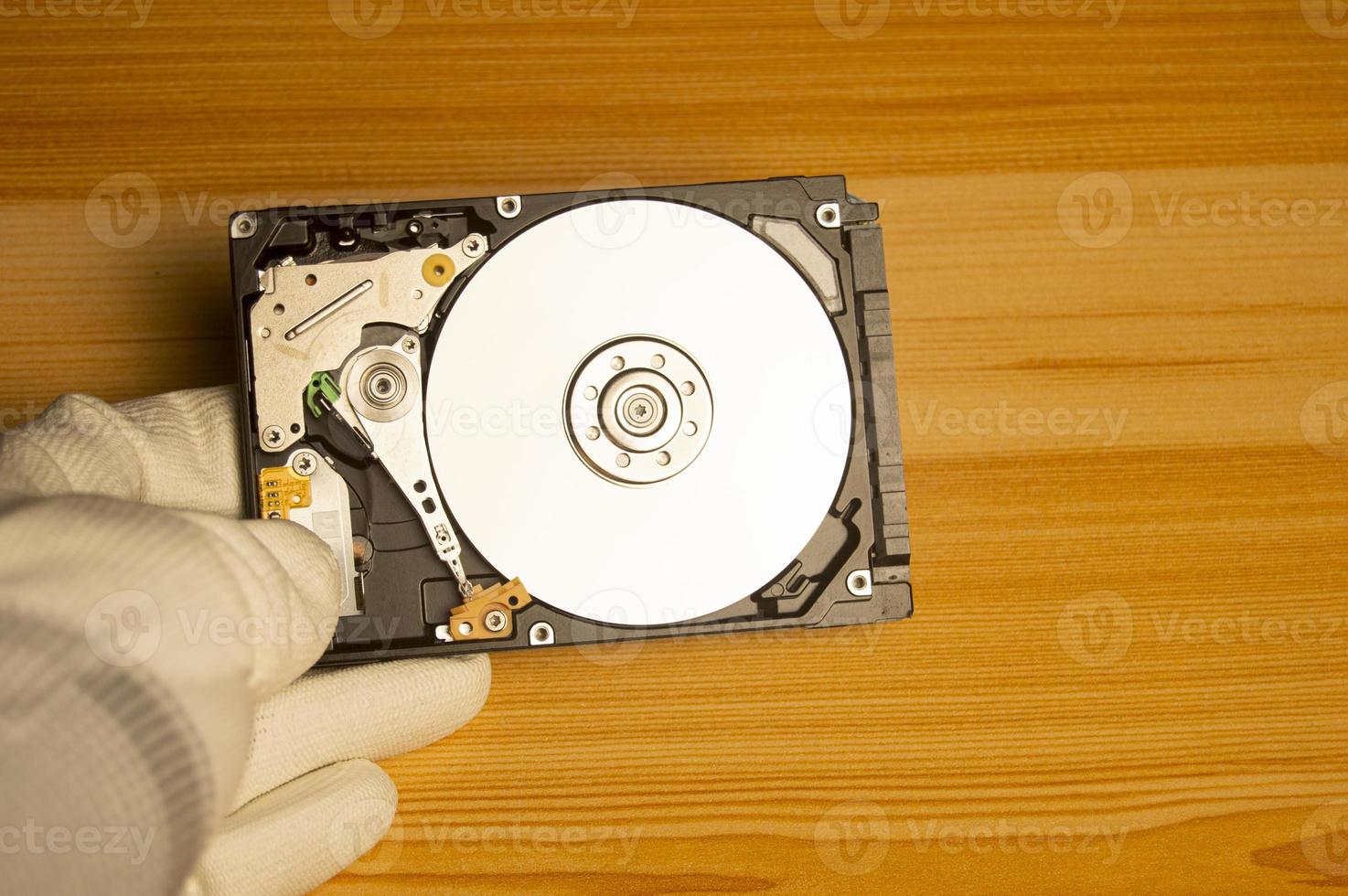 top view mechanic holding hard drive photo