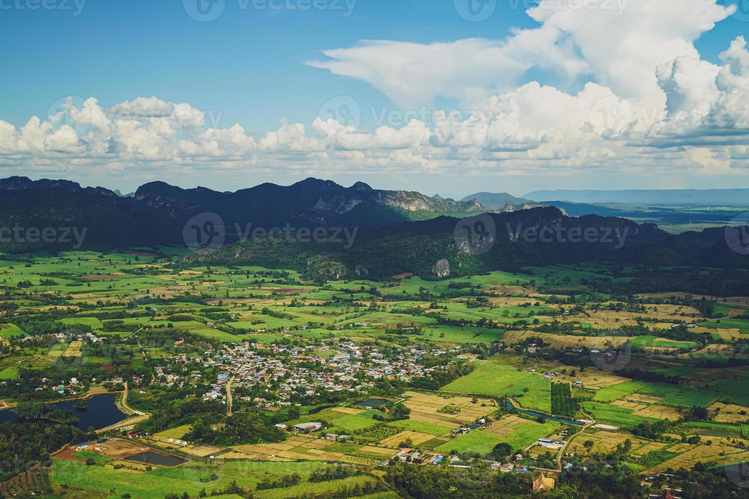 Picture from the highest point of Wat Khao Sam Yot.  Phu Pha Man District  Khon Kaen province with the sky, rice fields, mountains surrounding the countryside in Thailand. photo