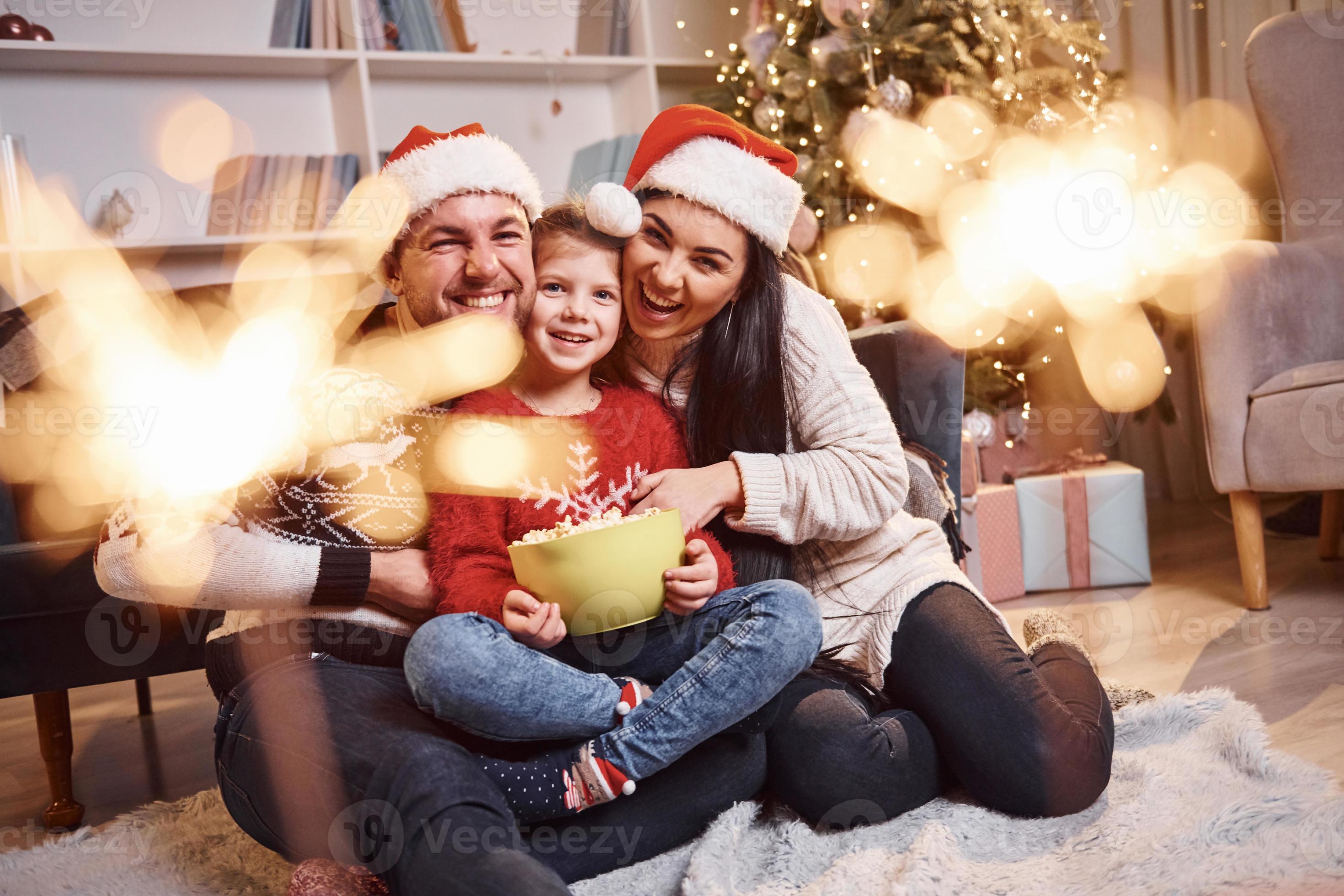 Happy family indoors in christmas hats have fun together and ...