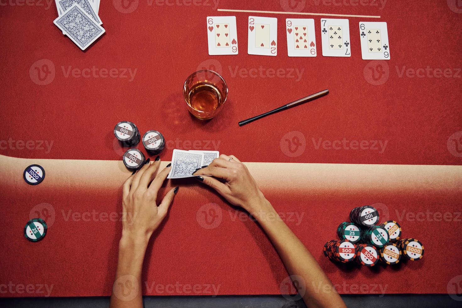 Top view of woman's hands. Girl plays poker game by table in casino photo