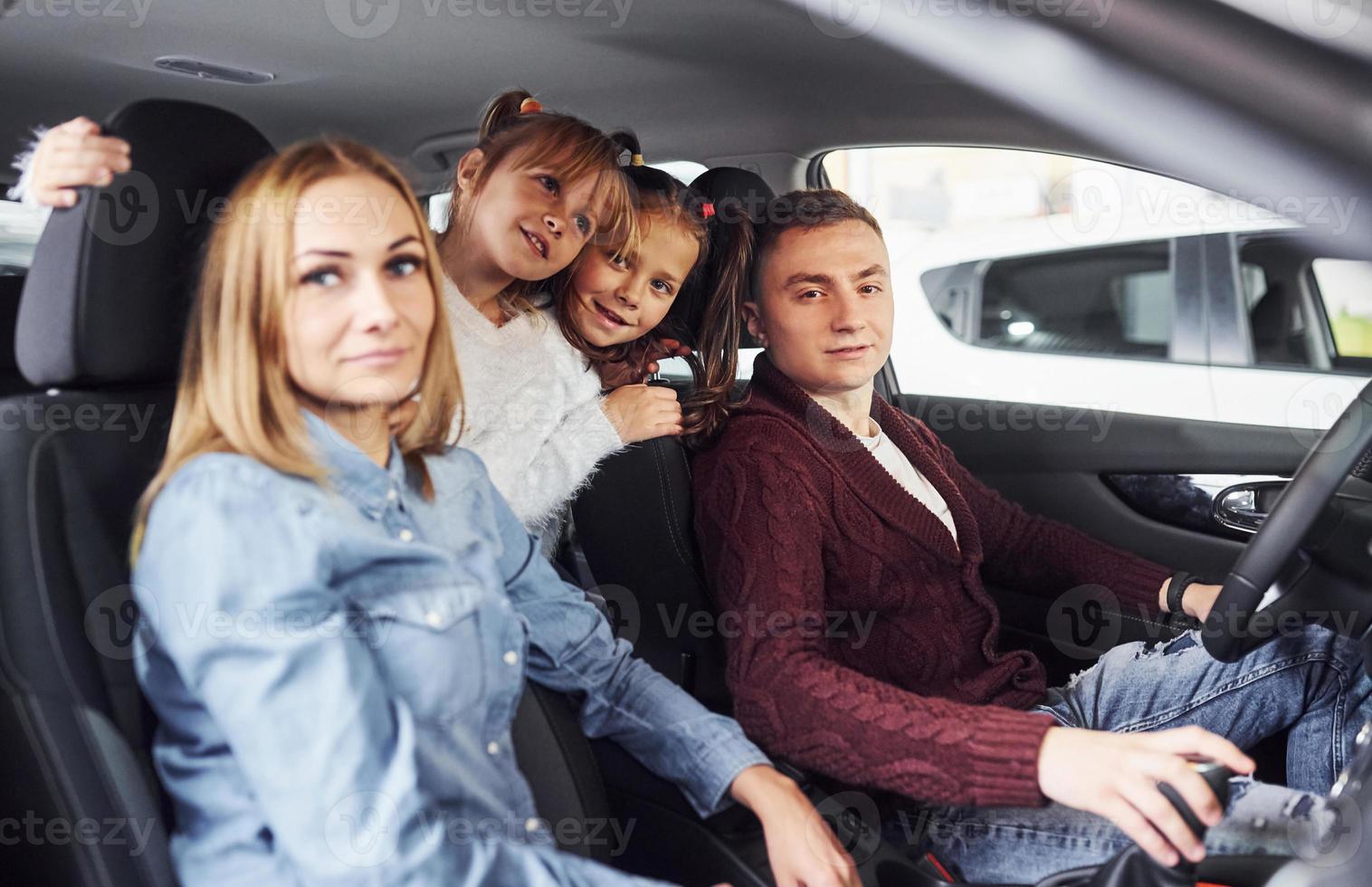 Cheerful family riding in a car together. Having fun and good weekend photo