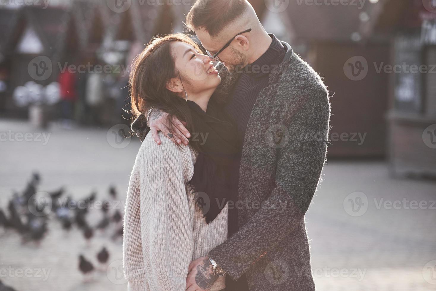 Asian girl with her caucasian boyfriend have fun outdoors in the city photo