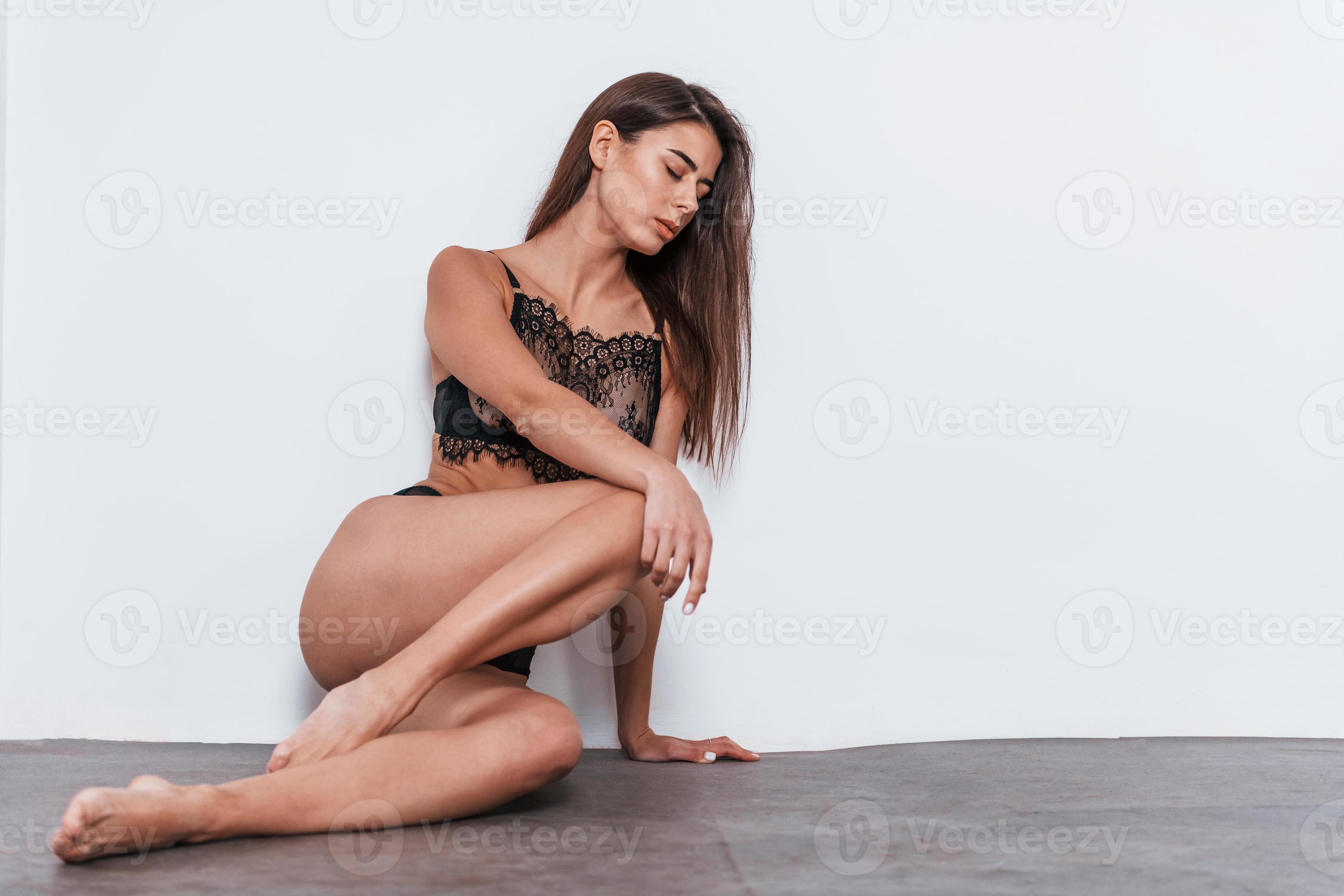 Sexy woman in black underwear standing in the studio against grey  background 15248984 Stock Photo at Vecteezy