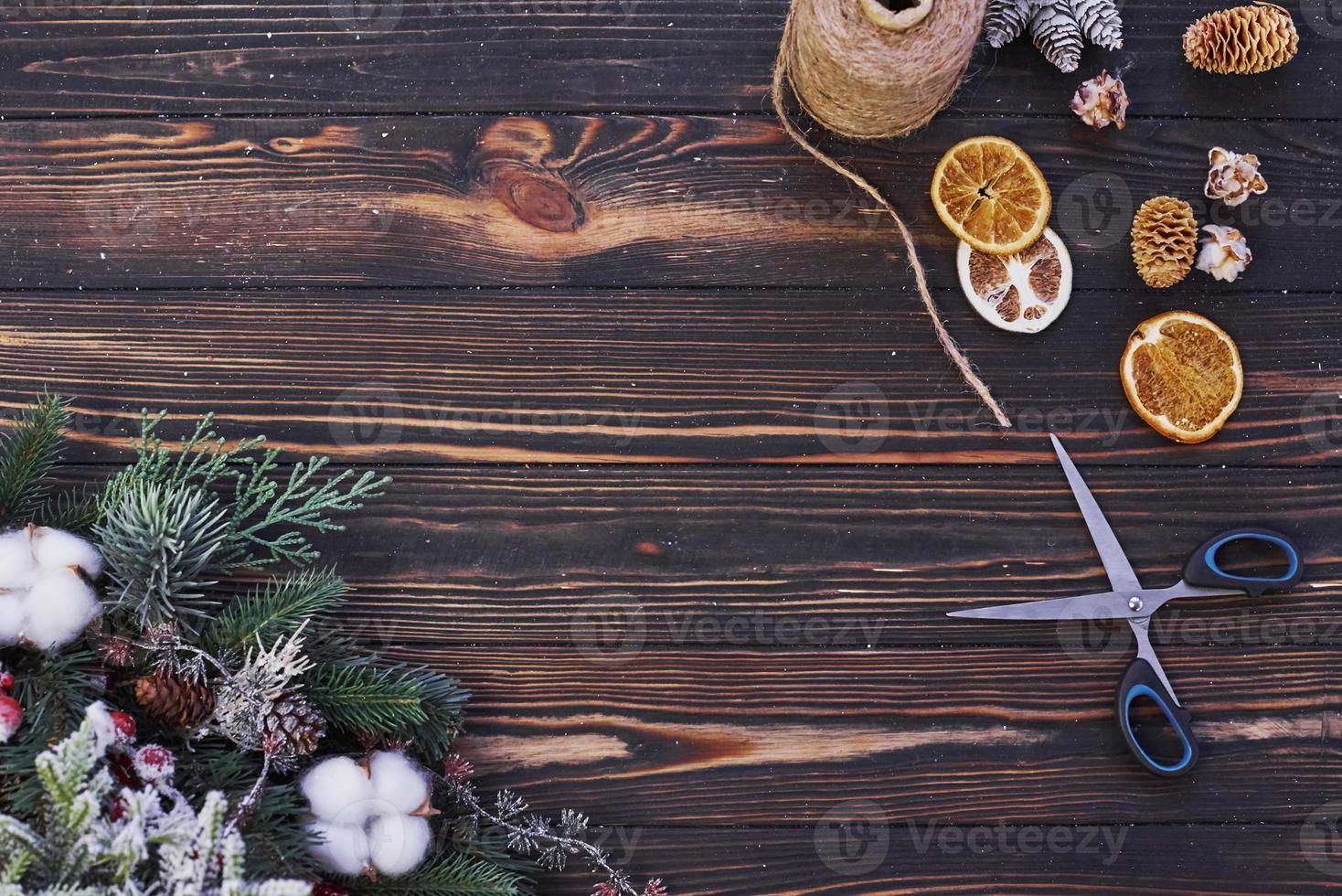 Scissors on the table. Top view of christmas festive frame with new year decorations photo