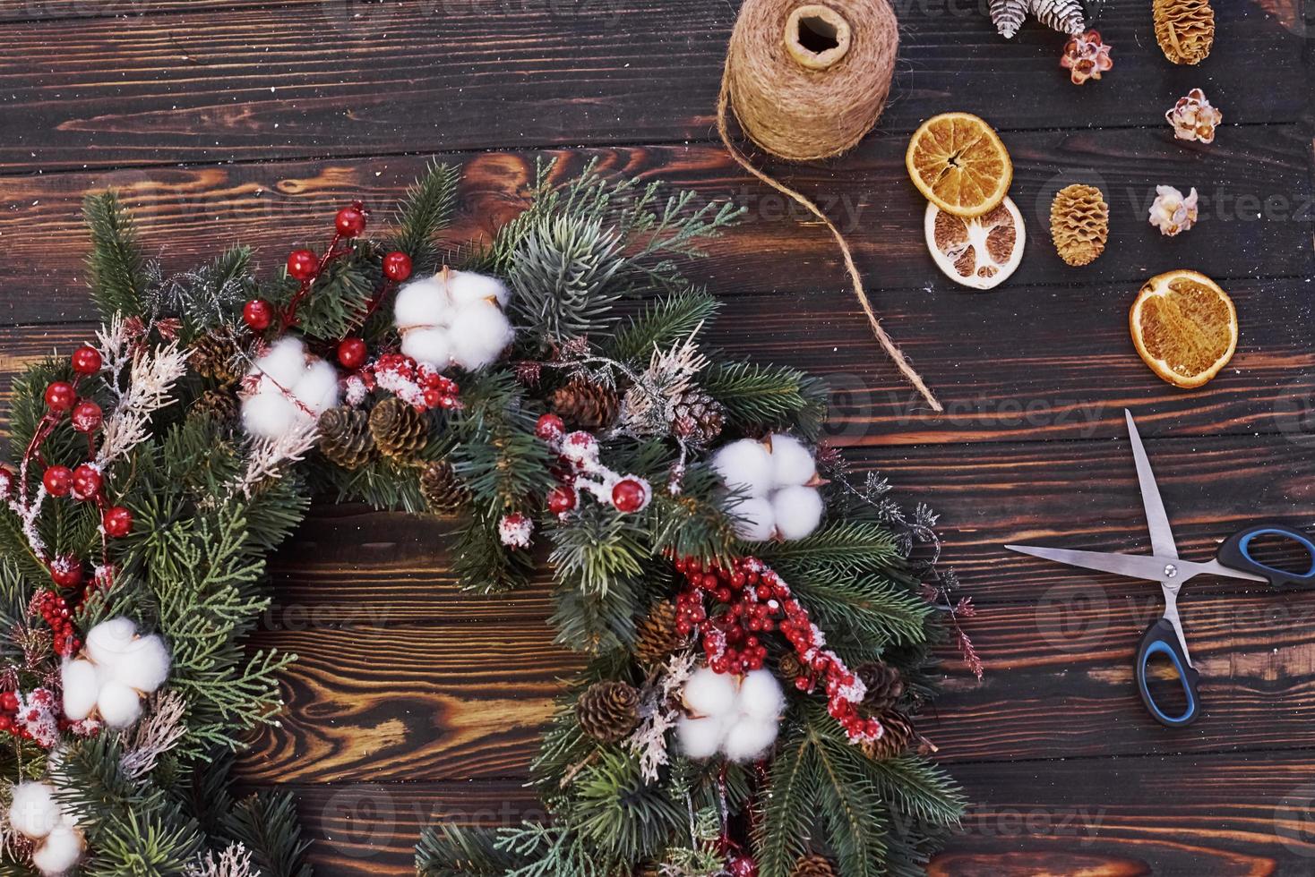 Scissors on the table. Top view of christmas festive frame with new year decorations photo
