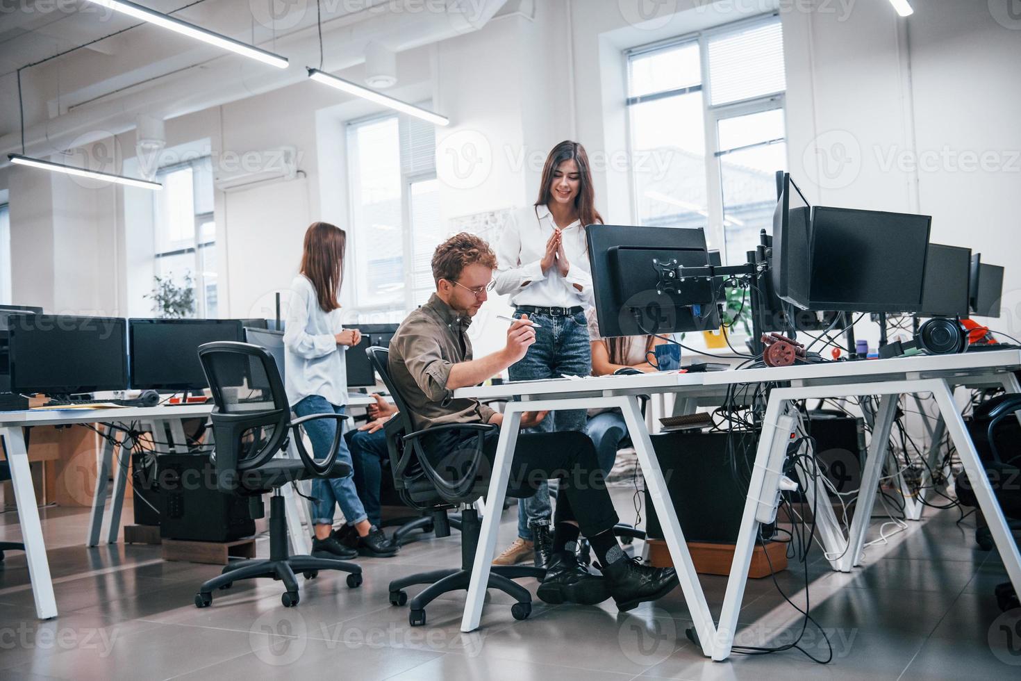 Group of young business people that working by computers in the modern office photo
