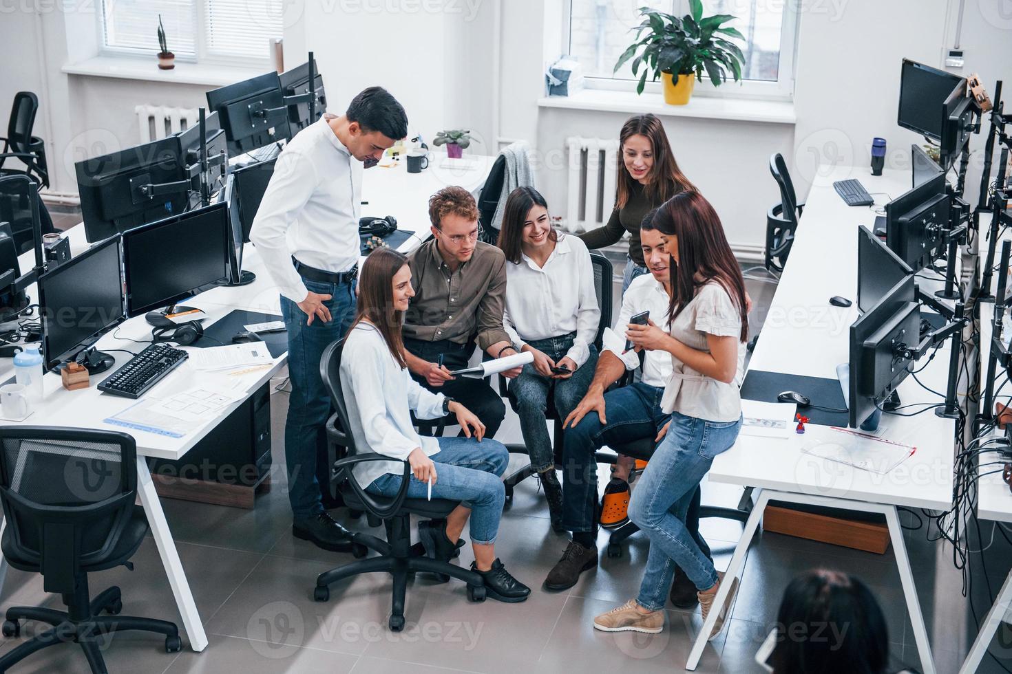 Concentrated group of people working on new project in the office photo