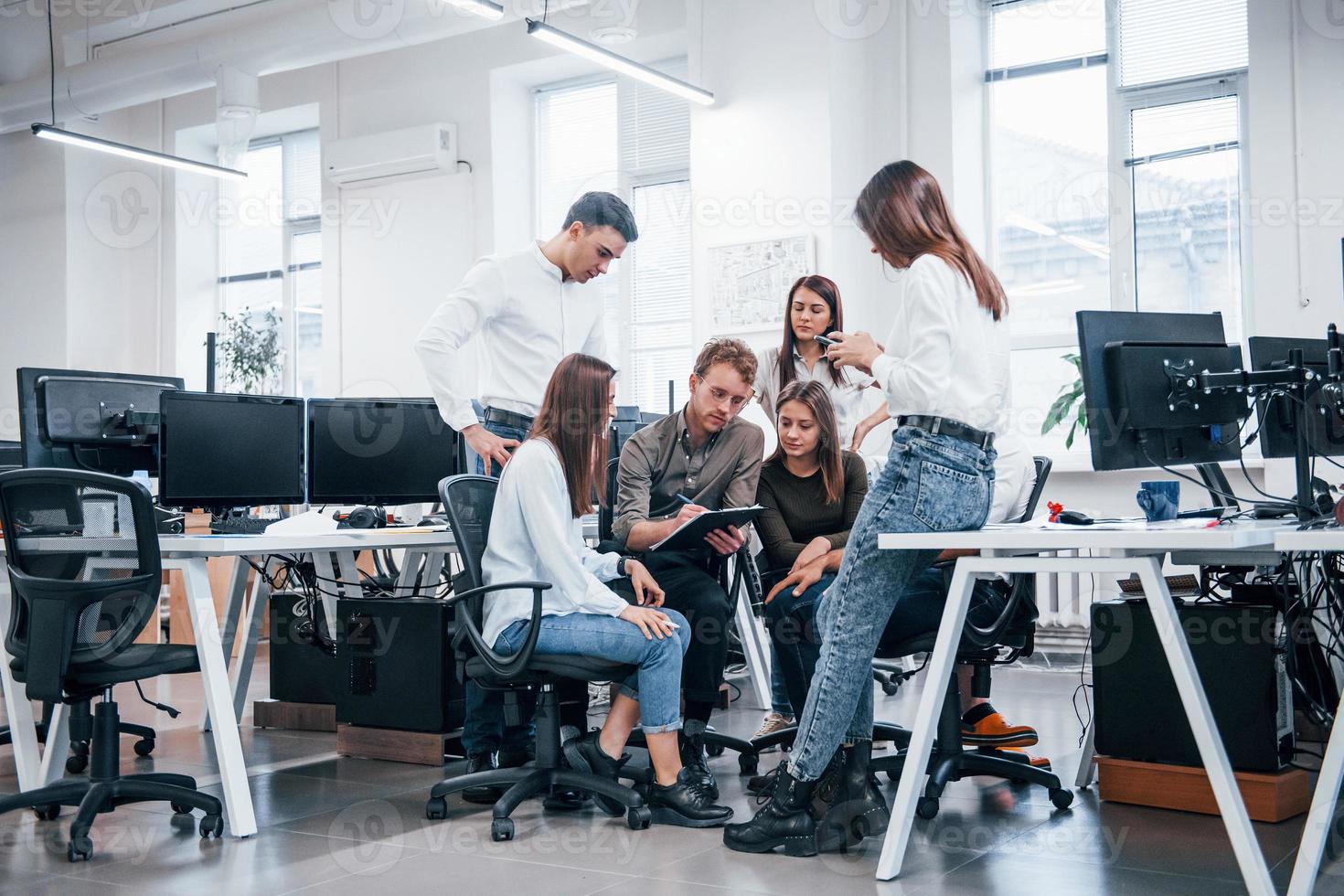 Group of young business people that standing and sitting and working in the office photo