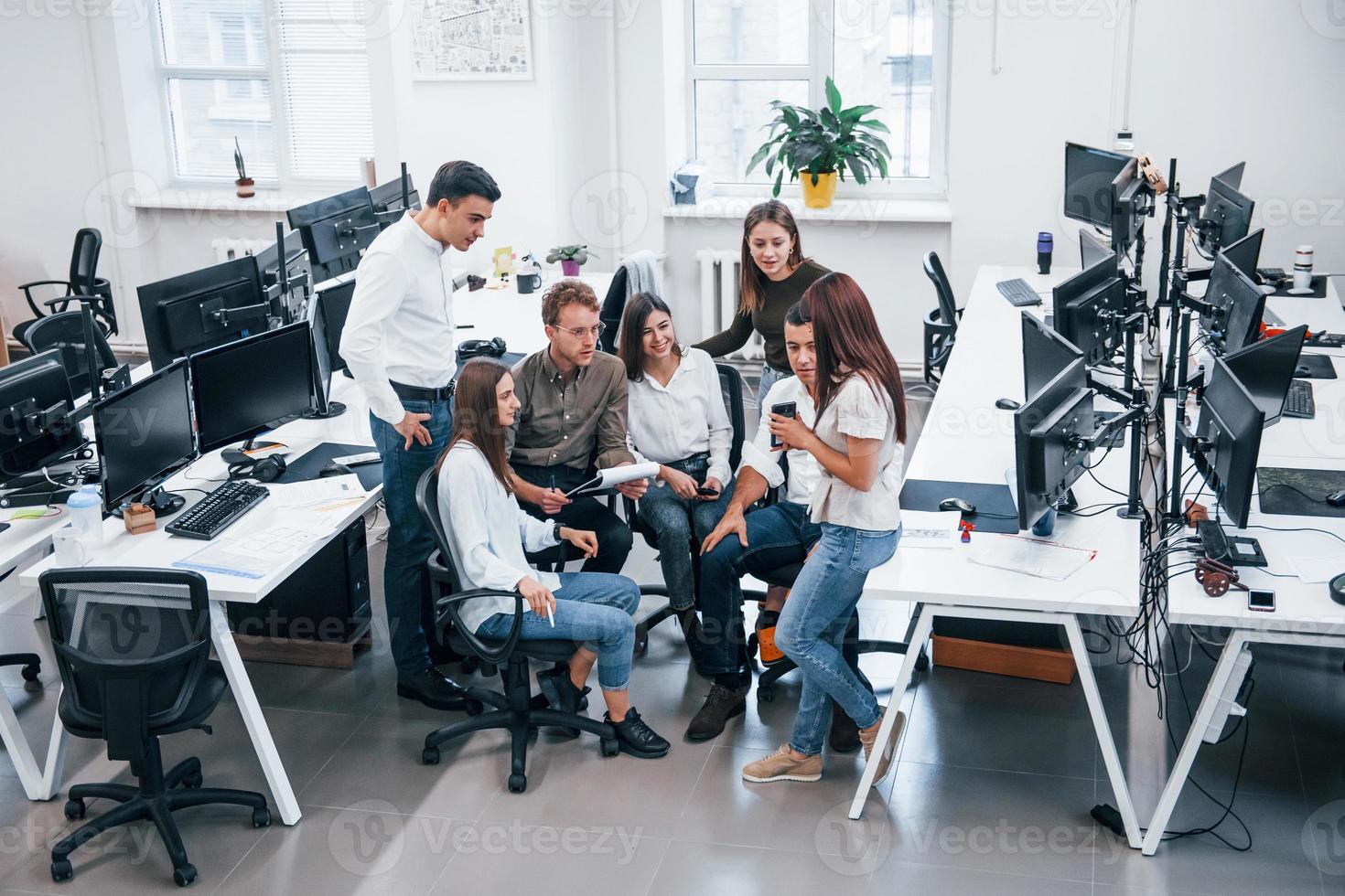 Concentrated group of people working on new project in the office photo