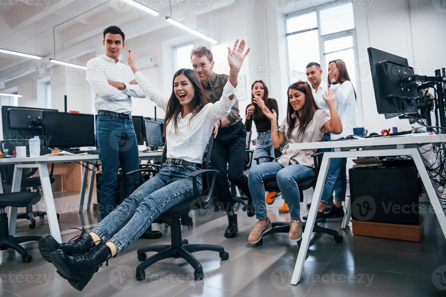Positive young people have fun at break time in the office photo
