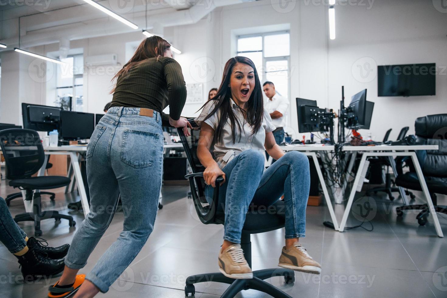 Positive young people have fun at break time in the office photo