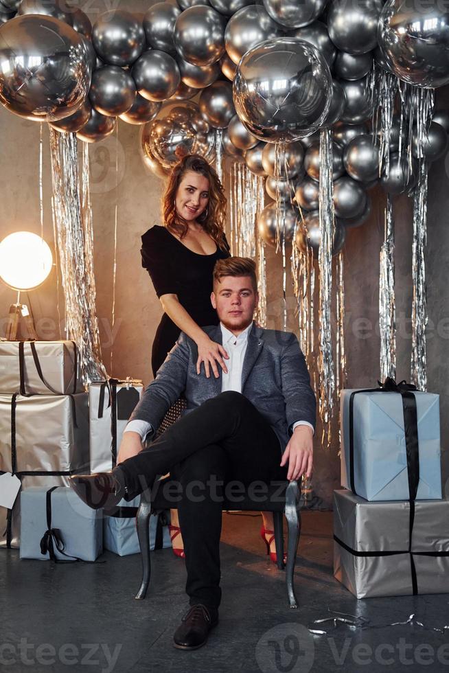 Couple is in christmas decorated room together. Celebrating New Year photo