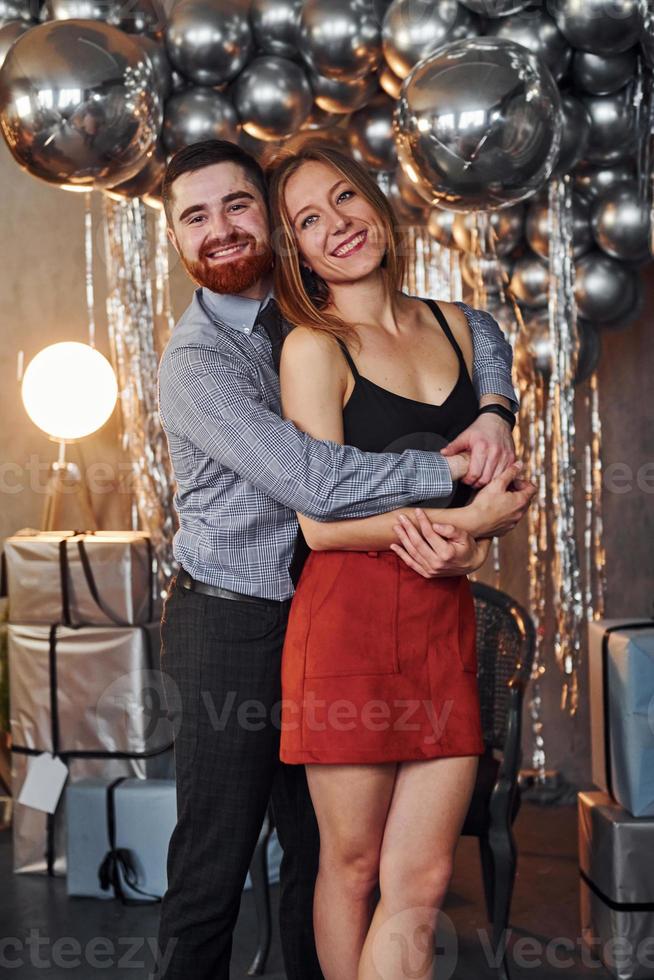 Couple is in christmas decorated room together. Celebrating New Year photo