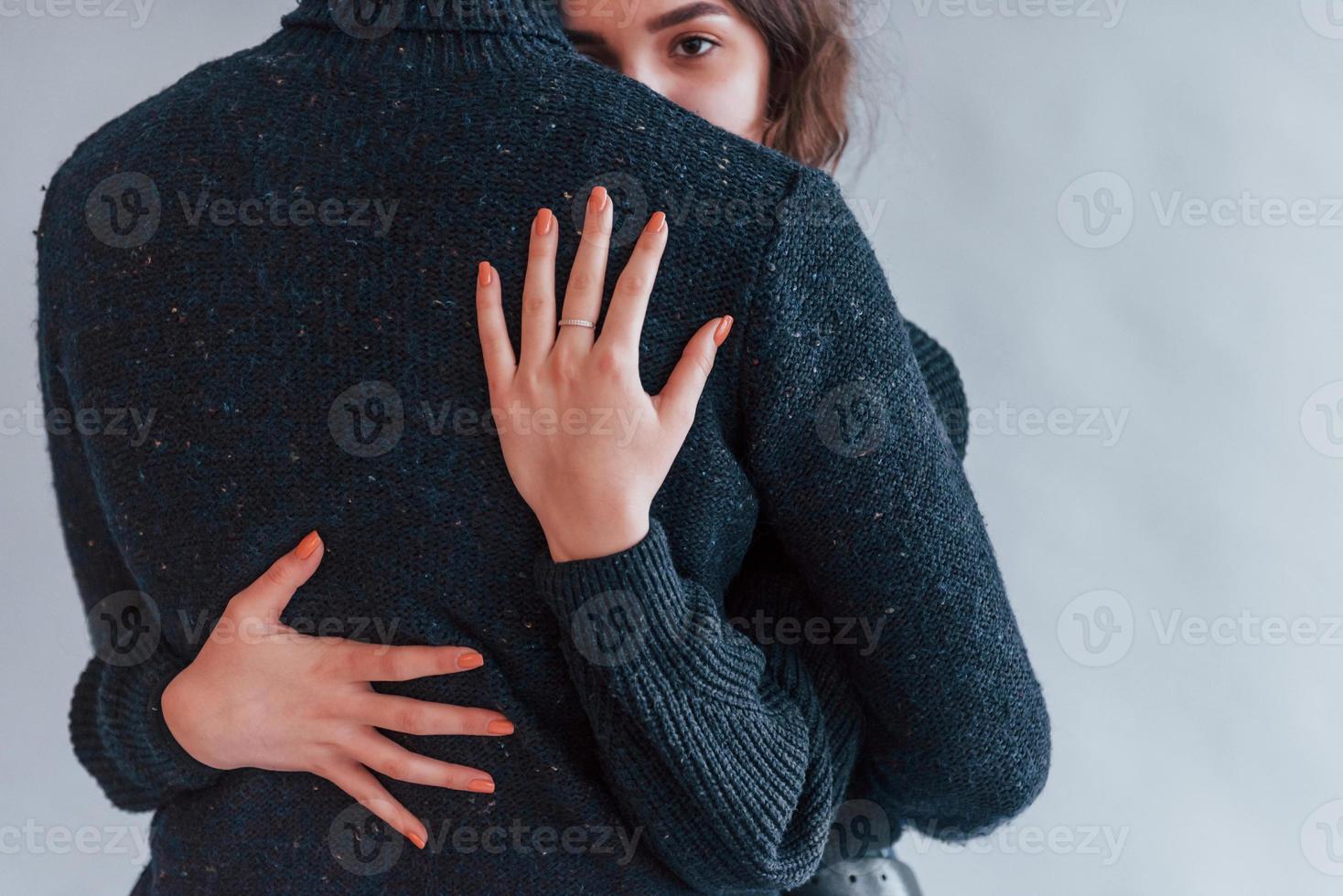 linda pareja joven abrazándose unos a otros en el interior del estudio foto