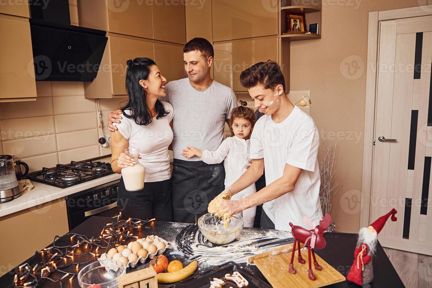 Happy family have fun on the kitchen and preparing food photo