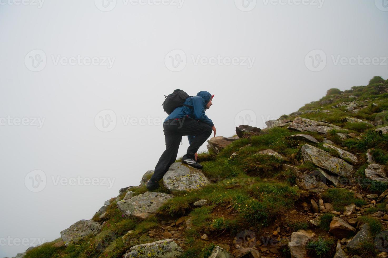 tourist walking through rocky land photo