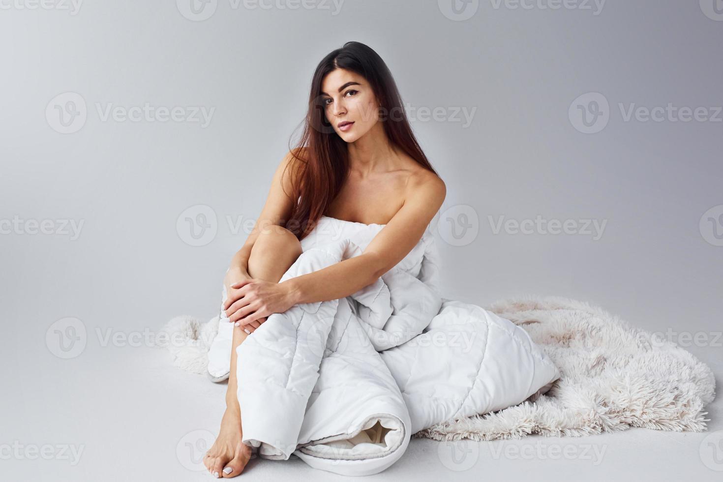 Woman in underwear in the studio against white background photo