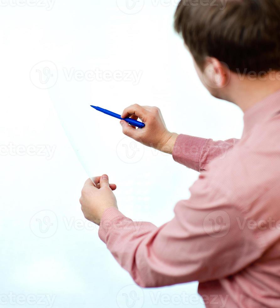 man writes on white photo