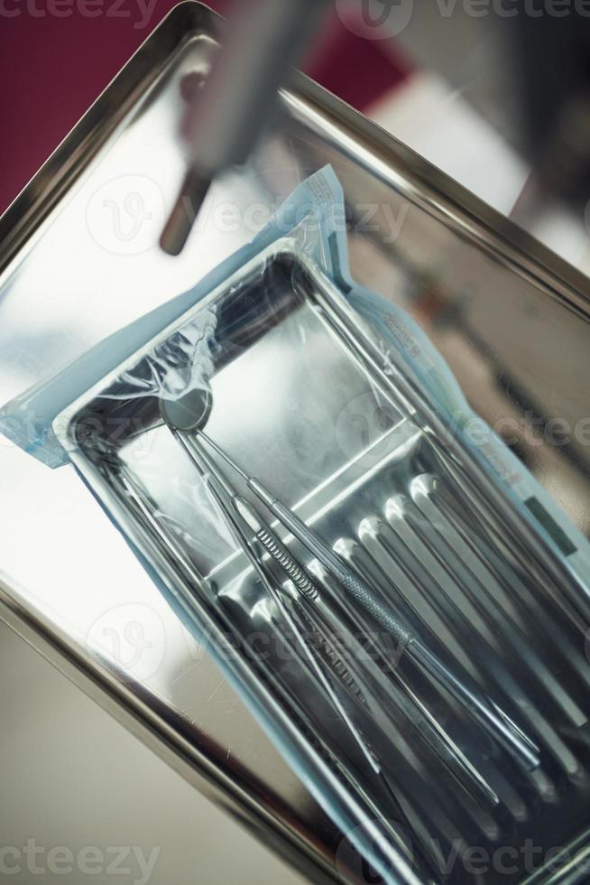 Top view of different dental tools inside of new package in clinic photo